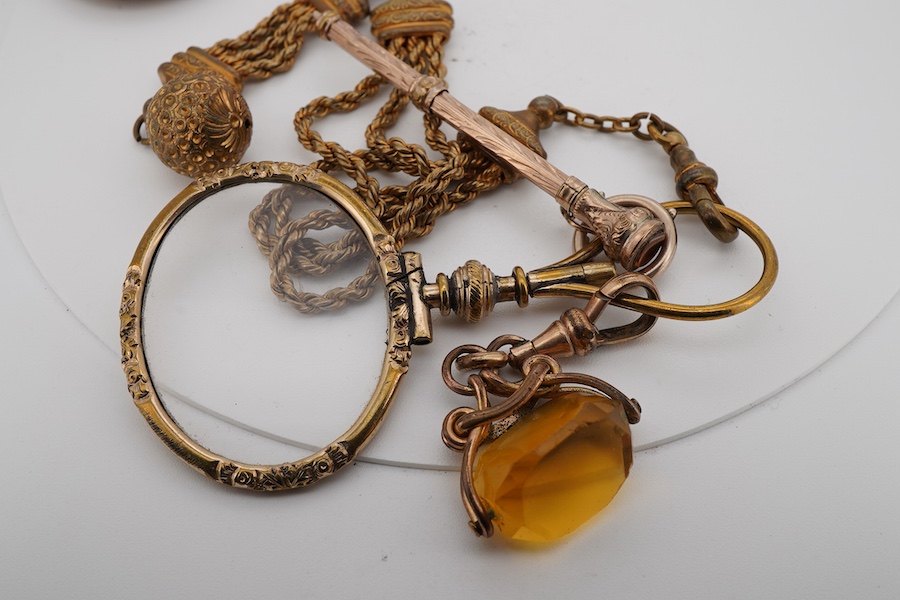 A gilt metal mounted eye glass, pencil and fob seal, suspended from a gilt metal albertina, a pendant and a propelling pen.